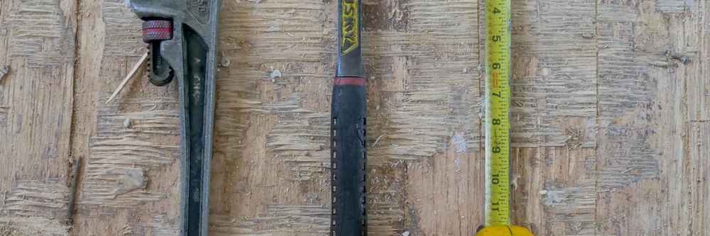 Construction tools and architectural plans for a fix and flip project